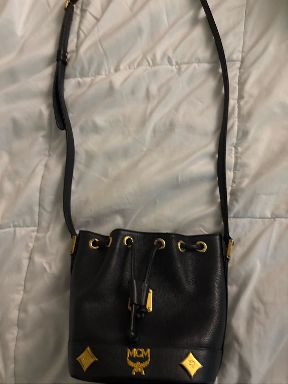MCM Black Leather Drawstring Crossbody Bag with Gold Accents